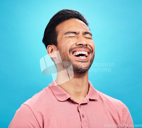 Image of Laughing, funny comedy and man in studio isolated on a blue background. Comic, humor and male person laugh at joke, laughter and happiness, cheerful and carefree for hilarious smile, excited or emoji
