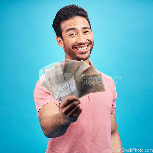 Image of Man in portrait, money fan with financial freedom and cash, prize or reward isolated on blue background. Finance with savings, bonus and payment, happy male person with economic success in studio