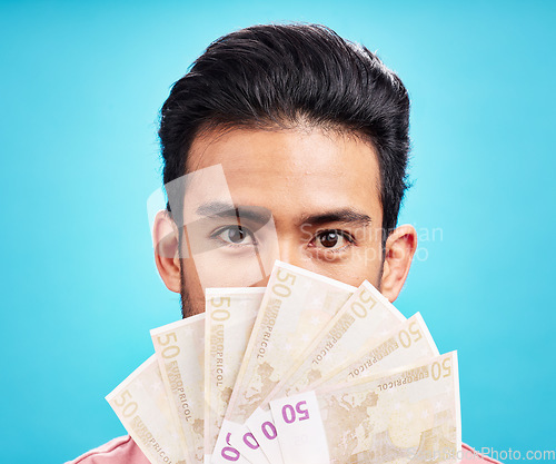 Image of Man in portrait, money fan and cash with finance, prize or reward isolated on blue background. Financial savings, bonus or competition win with payment, male person with economic success in studio