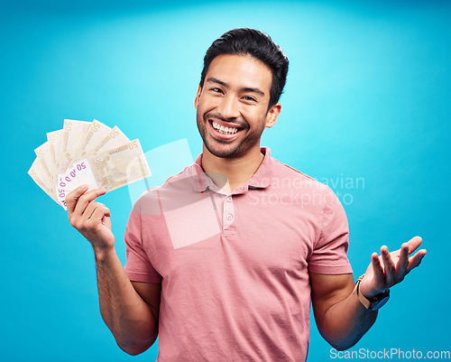 Image of Happy man in portrait, cash fan and financial freedom with money, prize or reward isolated on blue background. Finance with savings, bonus and male person with smile and economic success in studio