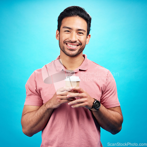 Image of Portrait, smile and Asian man with coffee, start motivation and confident guy against a blue studio background. Face, male person and happy model with cappuccino, tea and happiness with wellness