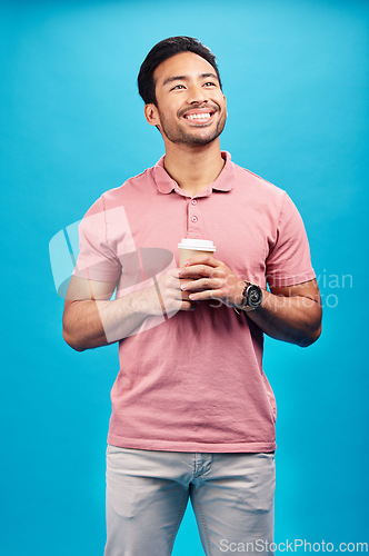Image of Thinking, smile and Asian man with coffee, ideas and decision against blue studio background. Thoughts, male person or happy model with cappuccino, tea or wonder with choice, happiness or opportunity