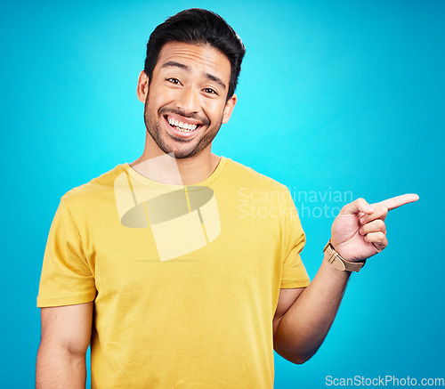 Image of Man is pointing, advertising and promo with happiness and branding isolated on blue background. Opportunity, deal or announcement, marketing news and promotion ad with happy male person in portrait