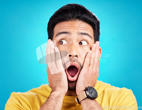 Image of Surprised, announcement and shocked face of a man or emoji reaction to a deal isolated in a blue studio background. OMG, fake news and male model with amazed facial expression in backdrop