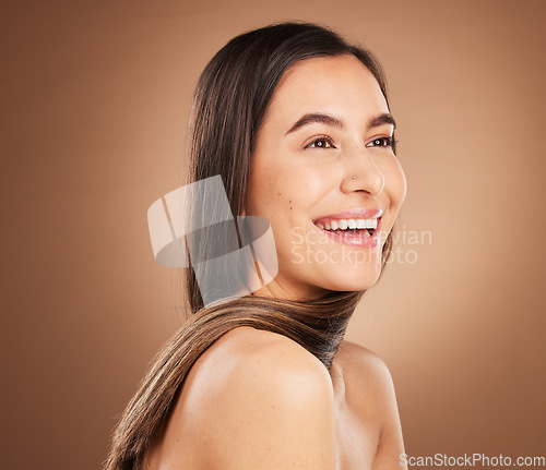 Image of Hair, beauty and face of woman in studio for wellness, hairstyle treatment and health on brown background. Salon aesthetic, luxury glow and happy girl with cosmetics, keratin growth and natural style