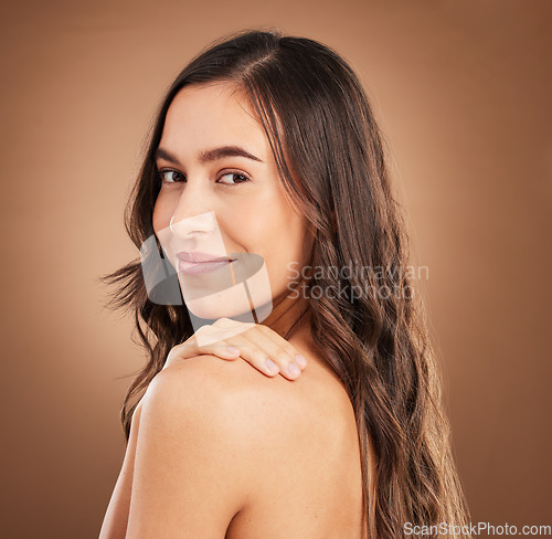 Image of Hair, portrait and happy woman in studio for beauty, treatment and cosmetics on brown background. Haircare, face and girl smile for natural, curly or wavy, texture or keratin, shine and confidence