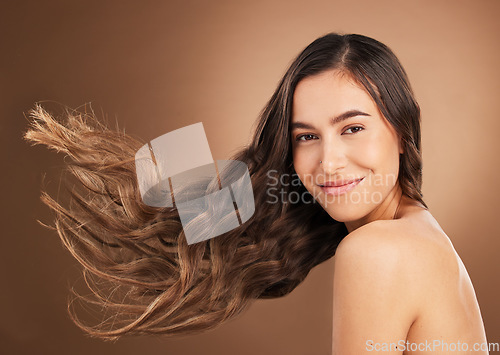 Image of Hair, beauty and portrait of woman in studio for wellness, hairstyle treatment and health on brown background. Salon aesthetic, smile and face of happy girl with cosmetics, keratin and natural style