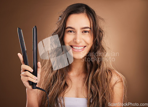 Image of Hair care, flat iron and portrait of happy woman on studio background, smile on face and salon hairstyle. Haircare shine, electric straightener and happiness, latino model with spa heat treatment.