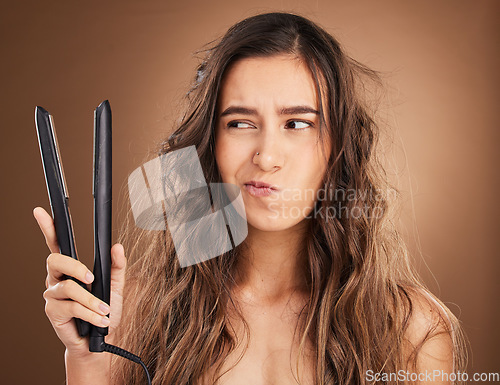 Image of Hair care, flat iron and damage, portrait of woman on studio background, worried face and salon hairstyle. Haircare problem, electric straightener and frustrated latino model with spa heat treatment.