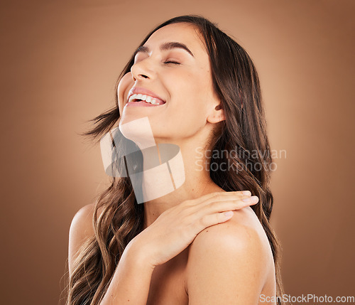Image of Hair care, happy and face of woman for beauty, hairstyle treatment and wellness on brown background. Salon aesthetic, smile and girl laugh with cosmetics, healthy texture and natural style in studio