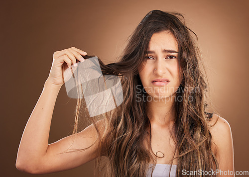 Image of Hair loss, problem and portrait woman in studio for beauty, messy and damage against brown background. Haircare, fail and face of sad girl frustrated with weak, split ends or tangle posing isolated