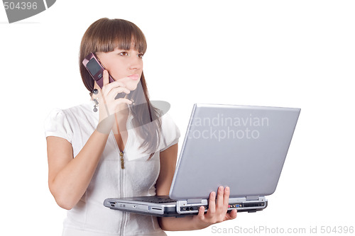 Image of Businesswoman with laptop speaks on the cell phone