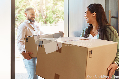 Image of Happy couple, boxes and moving in new home, property or real estate with cardboard box indoors. Man, woman and smile in happiness for mortgage loan, investment or purchase carrying packages inside