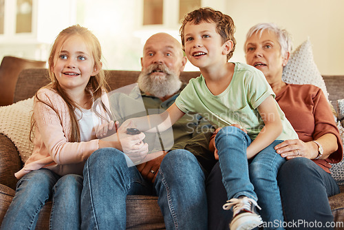 Image of Grandparents, tv and children in a home living room streaming a web series together. Senior people, kids and television remote watching a video on a house lounge couch with a child film and movie