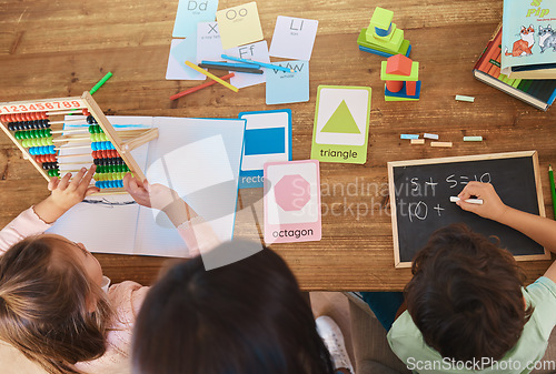 Image of Learning, education and study with family at table from above for homework, home schooling and child development. Math, lesson and creative with children and woman for knowledge, help and support