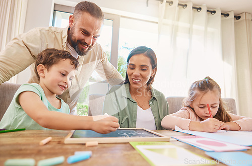 Image of Family, education and homework with a boy writing on a chalkboard while his parents supervise his learning. Kids, school or study with children, a mother and father at home for growth or development