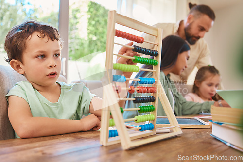 Image of Education, mathematics and a boy counting on an abacus while learning in the living room of his home. Children, homework and study with a male school kid in his house for growth or child development