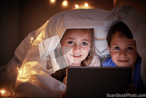 Image of Portrait, evening and kids in bedroom, tablet and streaming movies with happiness, bonding and quality time. Face, children and siblings online games, blanket and cover with smile, technology and joy