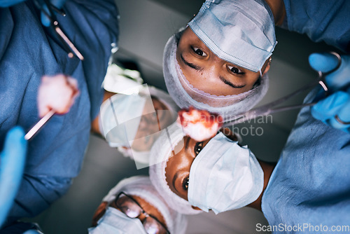 Image of Medical, surgery and pov of doctors in operating room for emergency, healthcare and teamwork. Insurance, medicine and treatment with group of people for injury, surgeon and operation from bottom