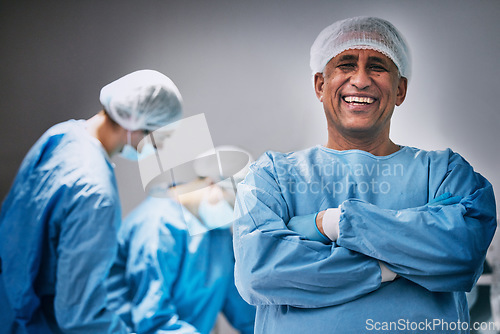 Image of Theatre, portrait and man doctor with arms crossed for hospital teamwork, leadership and medical surgery. Happy surgeon or healthcare person in operating room or theater for emergency and solution