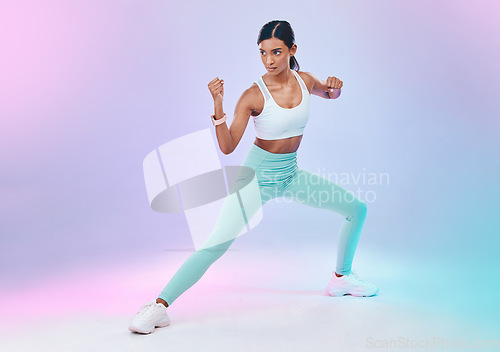 Image of Fitness, woman and fighting pose in studio for karate, martial arts or defence training on gradient background. Power, sports and indian female in intense workout, exercise and posing while isolated