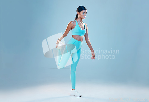 Image of Fitness, stretching legs and mockup with a woman in studio on a gray background for health or sports. Exercise, warm up and space with a female athlete training for a healthy body or lifestyle
