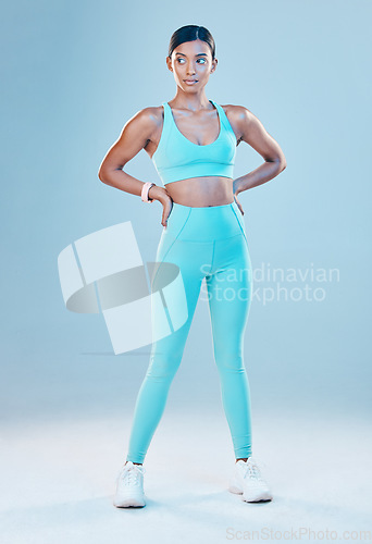 Image of Thinking, active and a woman for fitness in gymwear isolated on a studio background for exercise. Idea, sports and an Indian girl standing in workout clothing for training or a cardio idea for health