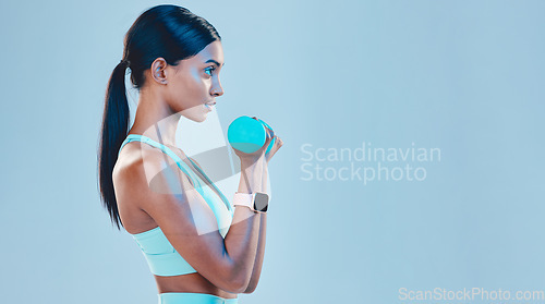 Image of Sports, workout and female with weights in studio for arm or strength training with motivation. Fitness, exercise and Indian woman athlete with dumbells isolated by blue background with mockup space.