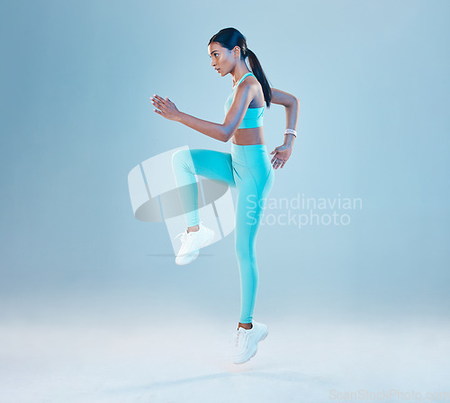 Image of Fitness, focus and mockup with a woman runner in studio on gray background for health or wellness. Exercise, mindset and space with a young female athlete running or training for cardio or endurance