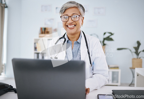 Image of Woman doctor, laptop and happy in hospital office while working online for consultation or research. Medical professional female with internet for advice, healthcare and innovation or management