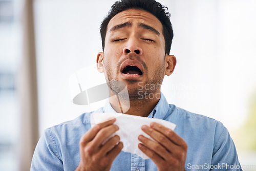 Image of Sick, sneeze and man with a tissue, allergies and sickness with symptoms, cold and illness. Male model, person and guy with congested with sinuses, toilet paper for nose and fever with health issue