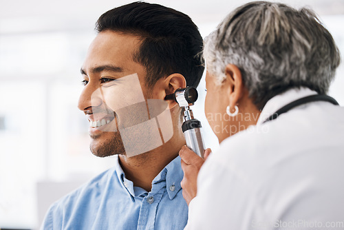 Image of Doctor check patient ear, healthcare and medical consultation at hospital with otolaryngology specialist. Happy man and physician woman with otoscope, test for hearing problem and health insurance