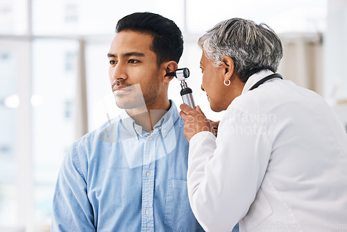 Image of Doctor check patient ear, consultation and healthcare, people at hospital with otolaryngology specialist. Man and senior physician woman with otoscope test for hearing problem and health insurance