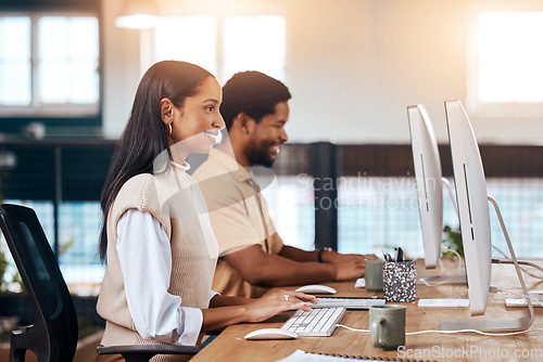 Image of Happy, coworking office and employees with a computer, working together and online communication. Smile, our vision and diversity with workers sitting at a desk typing on a pc for a corporate job