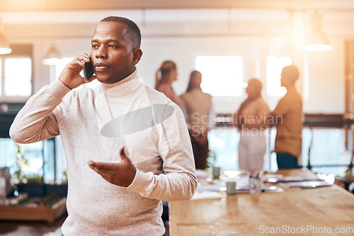 Image of Business, focused man and phone call on cellphone in busy office for communication, networking and contact. Black male talking on smartphone for conversation, mobile consulting or planning management