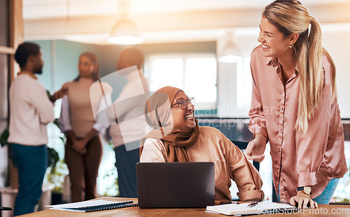 Image of Business people, laptop and happy mentor talking to muslim woman at office desk for motivation. Entrepreneur women laugh in office for discussion about coaching, management and planning or training