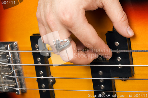 Image of Hand of the guitarist on guitar strings