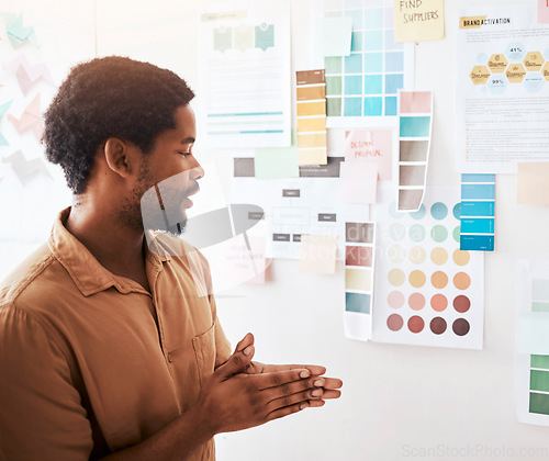 Image of Black man, color palette and planning in design, brainstorming or strategy on wall at office. Thoughtful Creative African male graphic designer looking at colors or ideas for project plan or startup