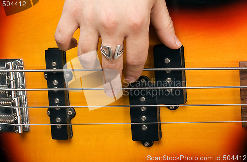Image of Hand of the artist on guitar strings