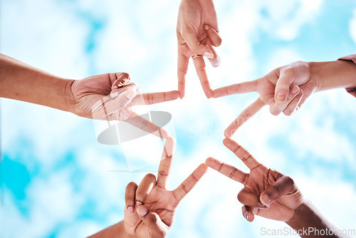 Image of People, hands and peace sign in collaboration, trust or unity in partnership or community star formation with sky below. Diverse group touching hands for teamwork, success or motivation in solidarity