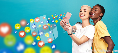 Image of Women, social media icons or friends take a selfie for content or online post on blue background. Love emojis, diversity or happy girls take pictures together on mobile app website or digital network