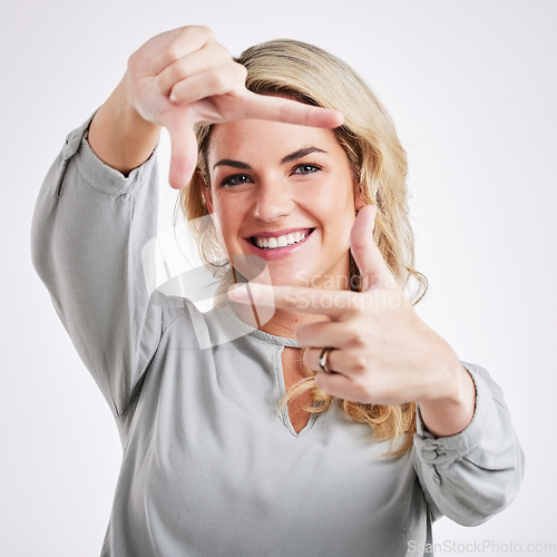Image of Happy woman, hands and frame for portrait selfie, photo or profile picture against a white studio background. Female border face and smiling in focus for perfect photography, social media or capture