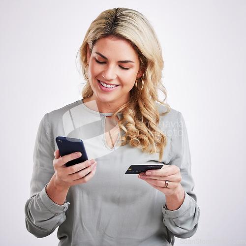 Image of Happy woman, phone and credit card for ecommerce, online shopping or payment against a white studio background. Female shopper buying on mobile smartphone app with smile for purchase or transaction