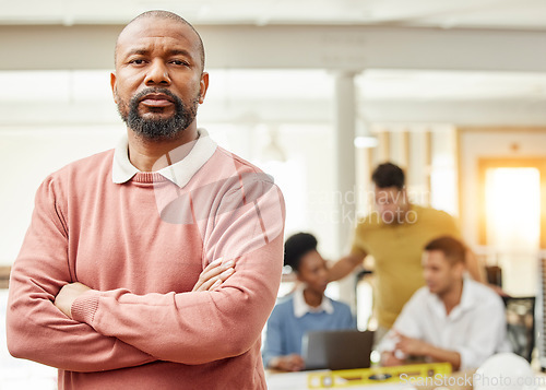 Image of Serious, business and arms crossed with portrait of black man in meeting for planning, leadership and mentor. Creative, training and strategy with employee in office for workshop and teamwork