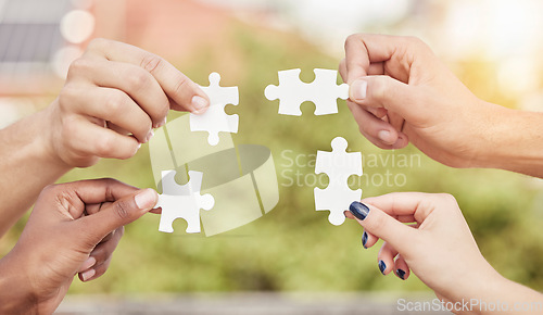 Image of Closeup group of people, hands and puzzle for teamwork, solution and problem solving for innovation. Team building game, jigsaw piece and collaboration of cooperation, synergy or planning integration