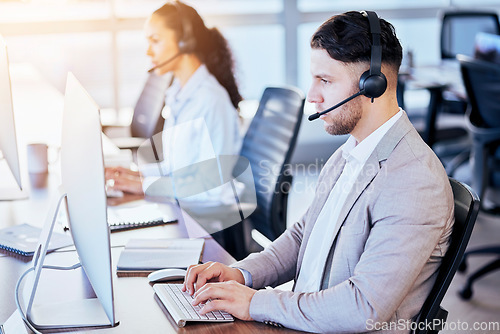 Image of Call center, computer and typing man in office for customer service, technical support and help desk. Telemarketing, contact us and communication with employee for sales advice, operator or crm focus