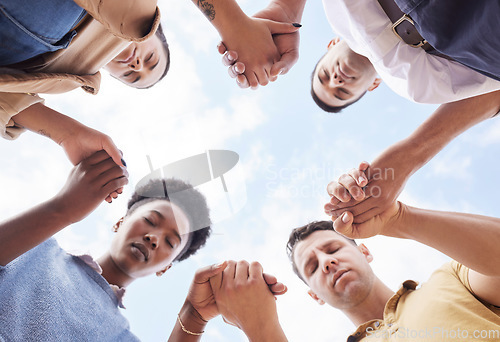 Image of Holding hands, prayer circle and business people with support, faith and diversity in low angle by sky. Men, woman and praying for worship, gratitude and progress of business with solidarity at job