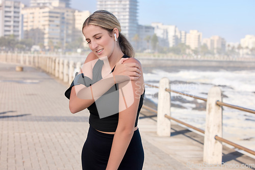 Image of Shoulder pain, fitness woman and music of a person running by the sea with a arm injury. Workout, sports and training accident of a female runner on a exercise run and muscle strain on arms outdoor