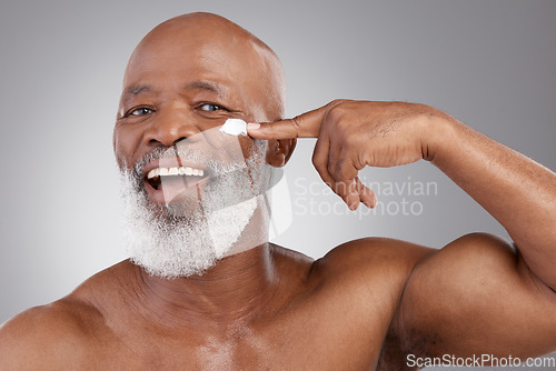 Image of Skincare cream, happy and portrait of old man for wellness, cosmetics and facial creme. Dermatology, beauty and male model apply anti aging lotion, face product and moisturizer on studio background