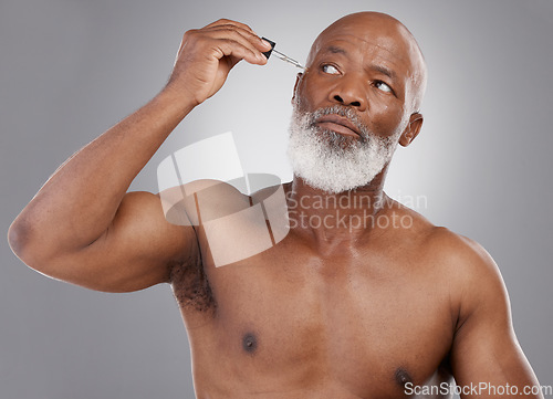 Image of Skincare, serum and face of senior black man for wellness, cosmetics and facial care on studio background. Dermatology, beauty and male person with essential oil for anti aging, wrinkle and hydration